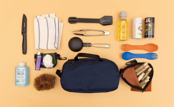 A Navy Parapack Grab Bag with items used for camp cooking next to it.
